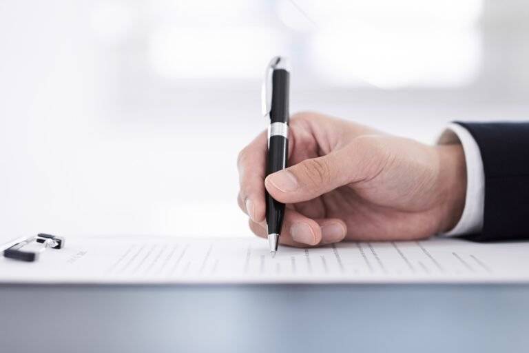 Japanese male businessman on hand to sign papers